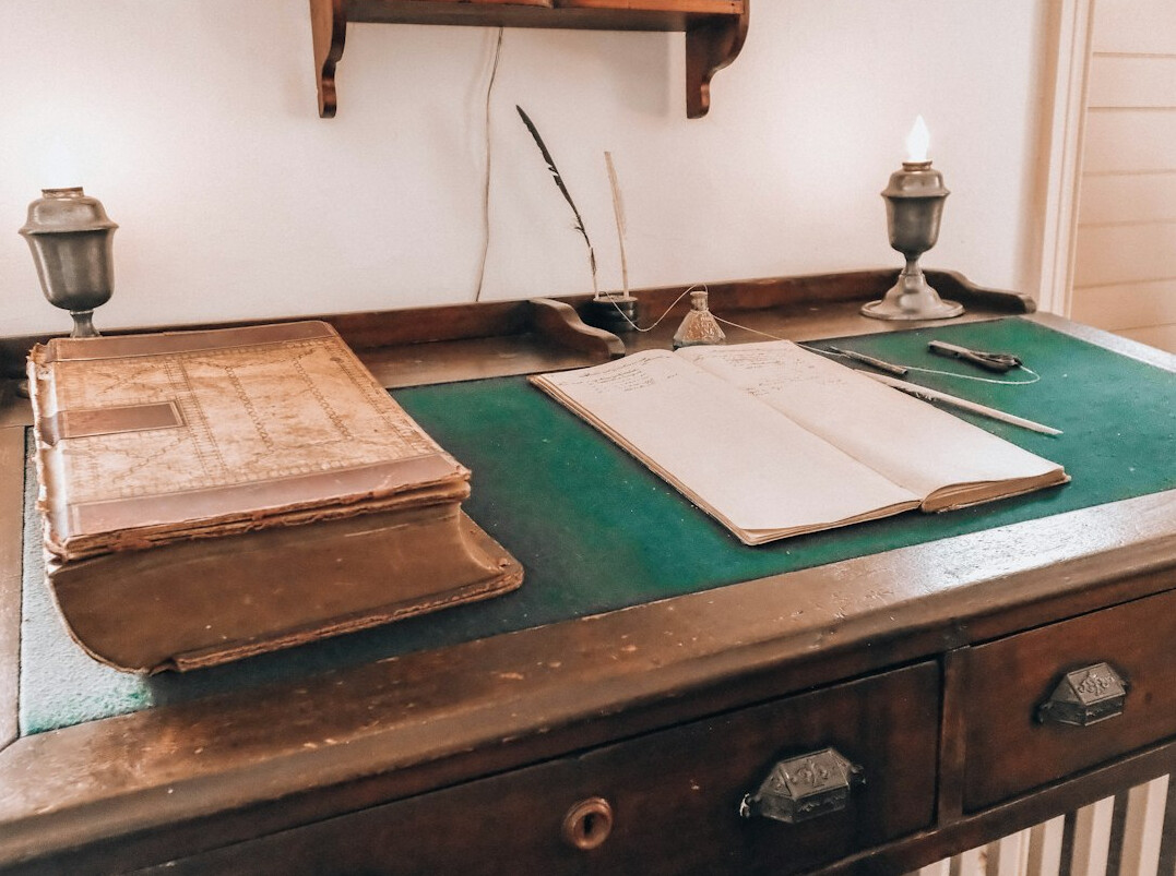 author at old desk with books